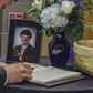 A mourner signs a guest book in June 2017 during the funeral for Otto Warmbier, who was imprisoned after being accused of taking down a propaganda poster in his hotel during a tour trip to North Korea
