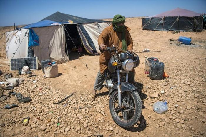 A Nomadic herder rides his motorcycle near tents in the southern Moroccan Tiznit province in the region of Souss-MassaDrought has turned parts of the plateaus of Tiznit arid, and when water becomes scarce, tensions rise