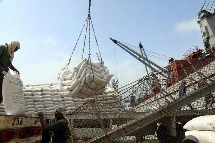 Yemeni workers unload wheat provided by the UN childrens's agency in Hodeida in January, 2018, before fighting for the lifeline aid port erupted between the rebels and the Saudi-backed government in June