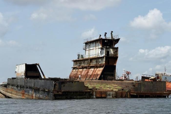 Graveyard: Dozens of shipwrecks and abandoned barges litter the Lagos waterways