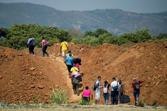 Venezuelans cross from their country through "trochas" -- illegal trails -- near the Simon Bolivar International Bridge into Colombia