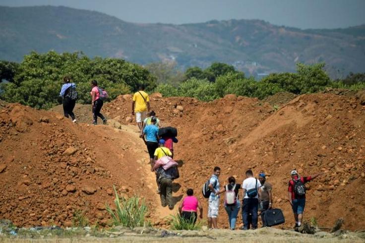 Venezuelans cross from their country through "trochas" -- illegal trails -- near the Simon Bolivar International Bridge into Colombia