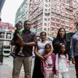 Sri Lankan refugees Nadeeka Nonis (3rd L) with her partner Supun Thilina Kellapatha (2nd L) and children Sethumdi (4th L) and Dinath (L) pose, seen in 2017 with others who sheltered ex-fugitive Edward Snowden, are seeking asylum in Canada