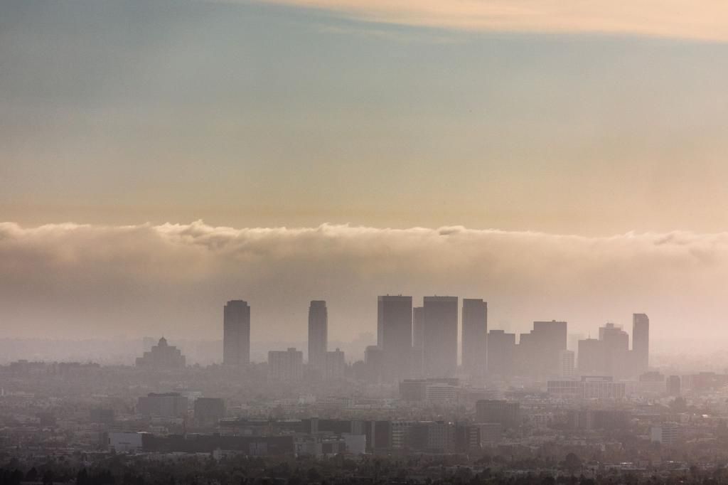 Modern Cityscape Against Sky During Sunset