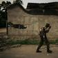 A soldier walks past a burnt building in Yumbi, where the December 16-17 massacre claimed 535 lives, according to a UN toll