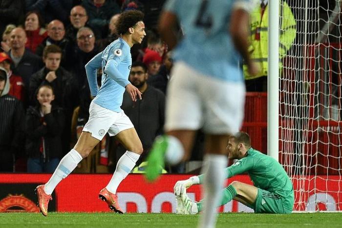 Manchester City's Leroy Sane (left) celebrates scoring his team's second goal against Manchester United