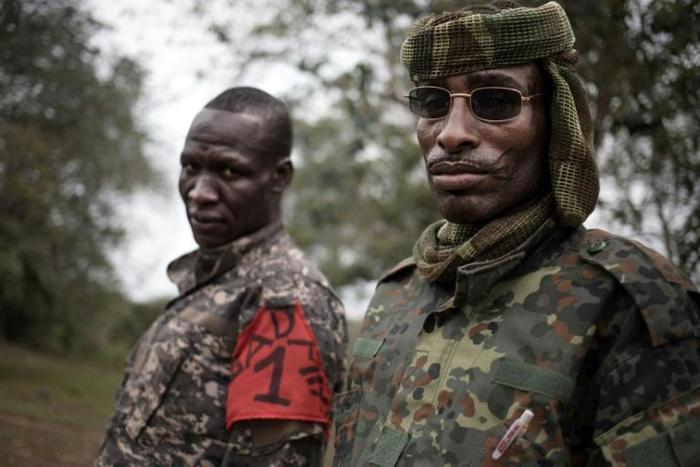 Two brigade leaders from the UPC armed group pose for photographs in the city of Bokolobo, near Bambari on March 16, 2019