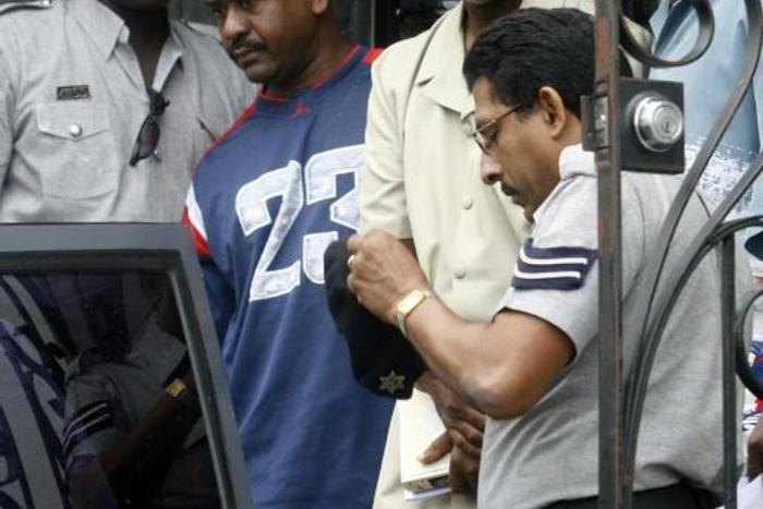 Abdul Kadir (center, in pale suit), a former Guyana parliamentarian, was sentenced to life in prison in the United States after being found guilty of plotting a 2007 bomb attack at John F. Kennedy International Airport in New York