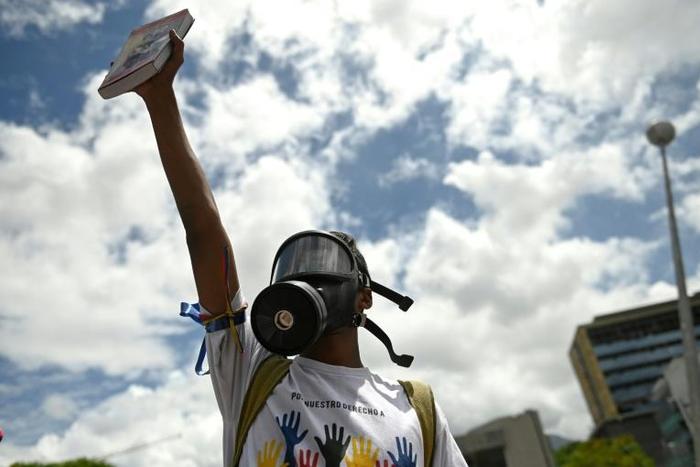 A Supporter of Venezuelan opposition leader and self-proclaimed interim president Juan Guaido protests during a rally in Caracas on May 11, 2019