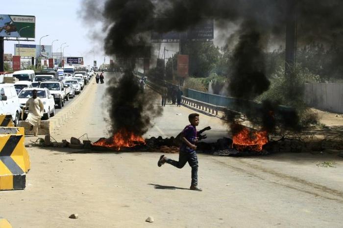 Sudanese demonstrators set fire to tyres to block a Khartoum road as the five-month protests show no signs of abating