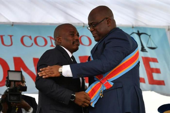 The formation of the new government by Felix Tshisekedi is being closely watched for signs that his predecessor Kabila will continue to hold sway in the nation's politics. Kabila, left, is shown here handing over power to Tshisekedi in January