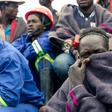 Miners watch rescue operations at a flooded gold mine near Kadoma in February where more than two dozen illegal diggers were drowned
