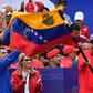 President Nicolas Maduro waves a Venezuelan flag at a rally to mark the 20th anniversary of the rise of power of the late Hugo Chavez