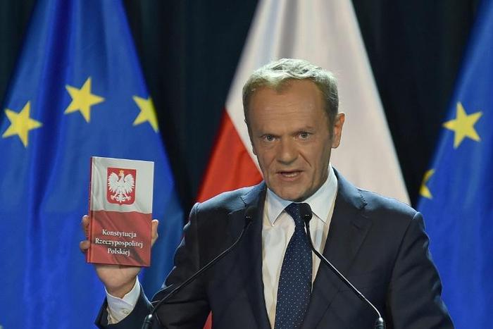 EU Council President Donald Tusk held up a copy of the Polish constitution during his speech