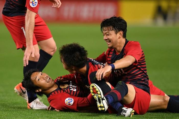 Hero super-sub: Sho Ito (second left is mobbed by teammates after scoring against Shandong Luneng