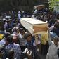 Relatives carry coffins of victims of the deadly fire which tore through apartment blocks in Bangladesh's capital Dhaka on Thursday