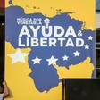 Workers set up posters for a charity concert for the Venezuelan opposition
