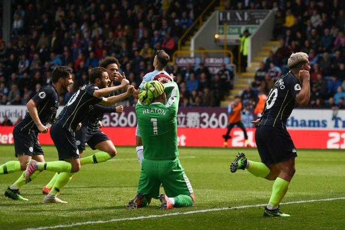 Inching ahead: Manchester City's Sergio Aguero (right) celebrates his vital winner at Burnley