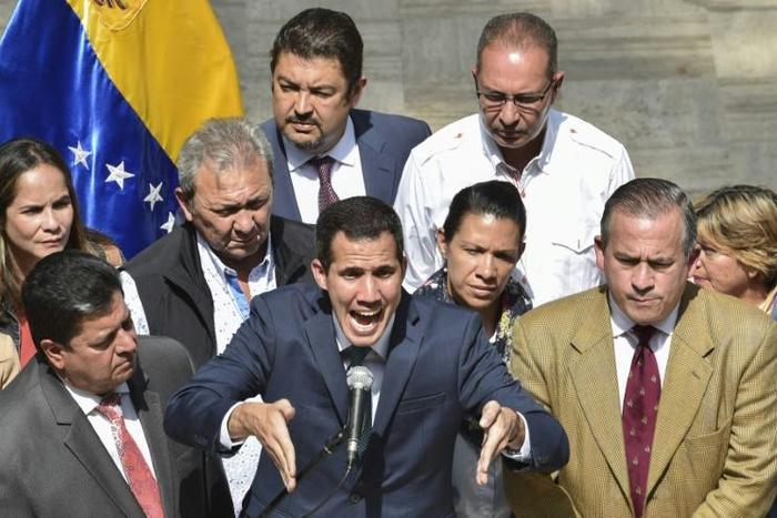 Venezuela's opposition leader and self-proclaimed acting president Juan Guaido speaks to the press at the Federal Legislative Palace, in Caracas, on February 4, 2019