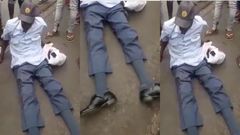 Crowd gather around drunk police officer as he is unable to rise up from the ground