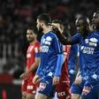 The match between Amiens and Dijon is interrupted, and Amiens' defender Prince Desir Gouano (C) points at supporters after hearing racists insults during the French L1 football match