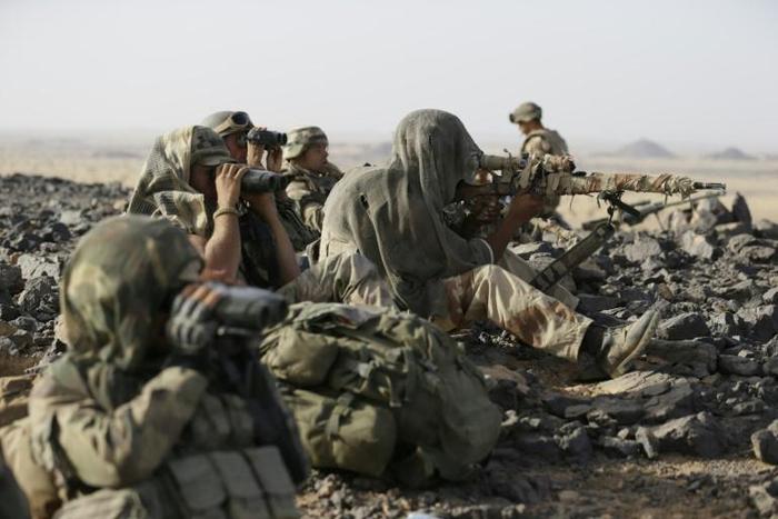 French army snipers deploy on the top of a hill during an operation on March 16, 2013, in northern Mali