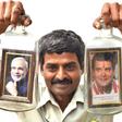 Message in a bottle ... artist Basavaraj poses with a creation showing Indian Prime Minister Narendra Modi and his election rival Rahul Gandhi