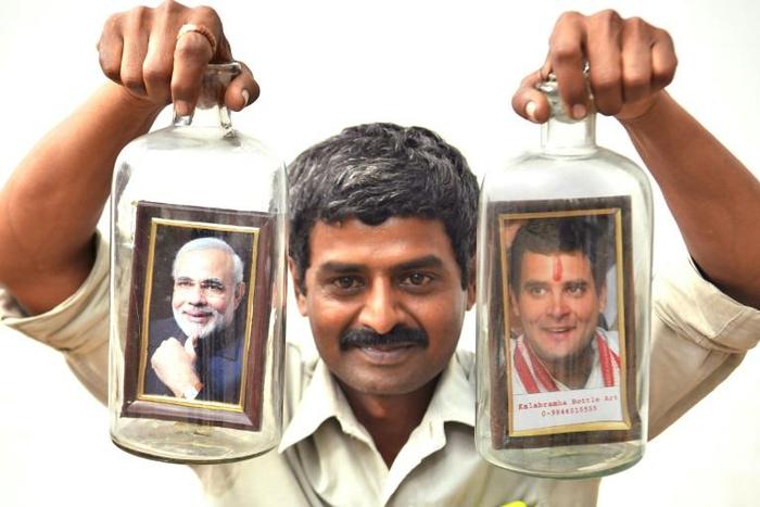 Message in a bottle ... artist Basavaraj poses with a creation showing Indian Prime Minister Narendra Modi and his election rival Rahul Gandhi