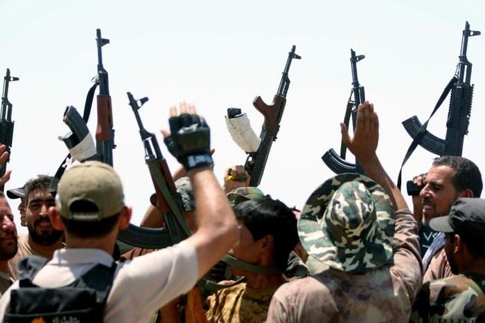 Iraqi government forces and members of the Popular Mobilisation units, forces dominated by Iran-backed Shiite armed groups, on the front line during the fight against the Islamic State group