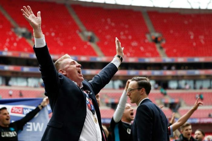 Wembley winner and grinner - Aston Villa manager Dean Smith celebrates the club's reurn to the Premier League after they beat Derby in the Championship play-off final