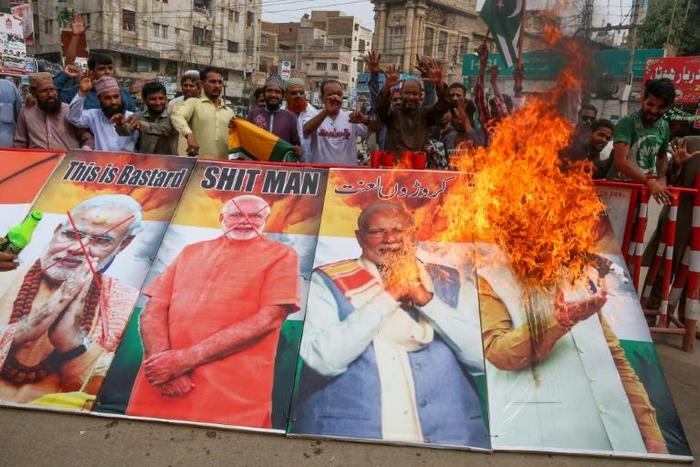 Protesters burn pictures of Indian Prime Minister Narendra Modi during a protest in Hyderabad after India stripped Kashmir of its autonomy: the UN Security Council is to hold a rare meeting on the Himalayan region on Friday