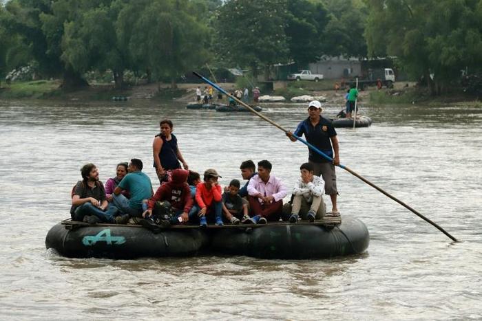 Locals and Central American migrants use a makeshift raft across the Suchiate river from Tecun Uman in Guatemala, to Ciudad Hidalgo in Chiapas State, Mexico, on June 11, 2019