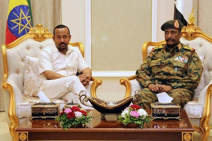 Days after a deadly crackdown on a protest camp in Khartoum, Ethiopia's Prime Minister Abiy Ahmed (L, pictured June 7, 2019) met with Sudan's ruling military council General Abdel Fattah al-Burhan (R) to try to mediate between the two sides