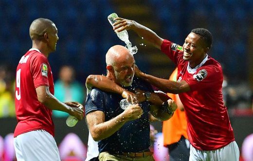 Madagascar coach Nicolas Dupuis is doused in water after an upset of African giants Nigeria