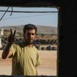 Mohammad al-Naeemi, a Syrian who returned from exile in Germany to join a rebel group, flashes a victory sign at a training camp near the Bab al-Hawa crossing between Iblib province and Turkey on July 18, 2019