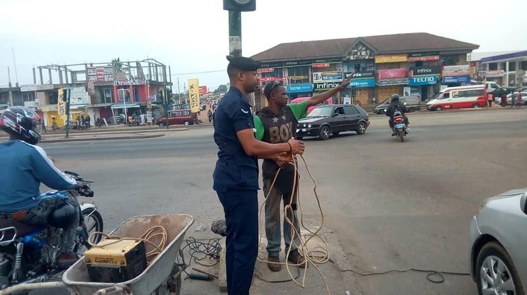 Police officer repairs non-functioning traffic light at Odorkor