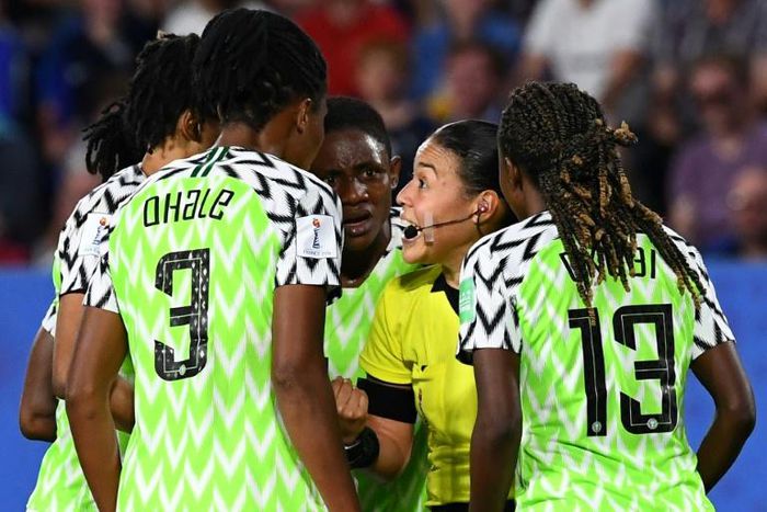 Nigeria players protest to the referee during their defeat against France after the hosts were allowed to retake the match-winning penalty