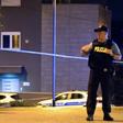 Police officers stand guard at a check point after six people were shot dead nearby in Zagreb, Croatia on August 1