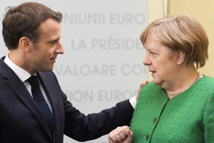 French President Emmanuel Macron and German Chancellor Angela Merkel are at loggerheads over who will be the next European Commission president