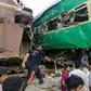 Rescuers and onlookers gather around the twisted wreckage of train carriages after the accident