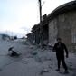 A man looks on at the site of a reported rocket attack by Syrian regime forces and their allies on the village of Kafr Nabl, south of the jihadist-held Syrian province of Idlib
