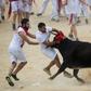 The daily runs see hundreds of people dressed in white shirts and red scarfs, sprint with bulls through narrow streets to the city's bull ring