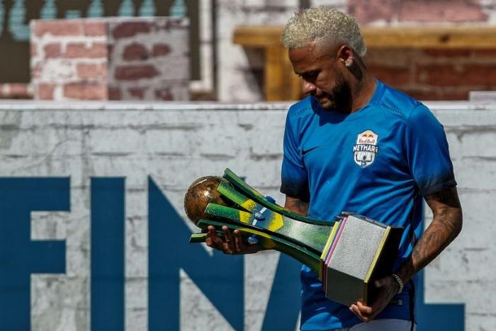 Brazilian football star Neymar holds a trophy during a five-a-side football tournament for his charity Neymar Junior Project Institute in Praia Grande, Sao Paulo, Brazil, on July 13, 2019