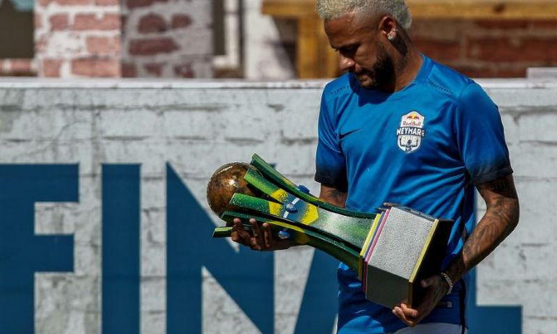 Brazilian football star Neymar holds a trophy during a five-a-side football tournament for his charity Neymar Junior Project Institute in Praia Grande, Sao Paulo, Brazil, on July 13, 2019