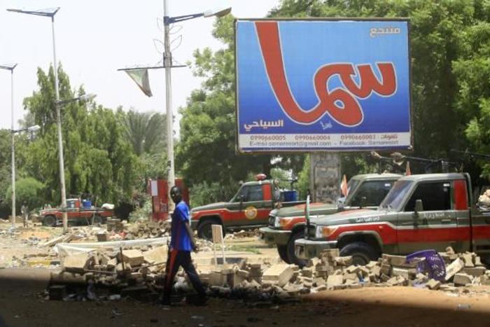 Fewer people than usual were on the streets of Khartoum, patrolled by heavily armed paramilitaries