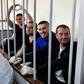 In the cramped courtroom, the sailors, who have described themselves as 'prisoners of war', were held in a metal-barred cage reserved for defendants