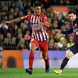 Atletico Madrid's Rodrigo Hernandez tussling with Barcelona striker Lionel Messi in April.