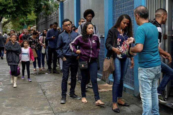 People queue in front of the Telecommunications Workers Union, where a weekly job fair takes place in Rio de Janeiro -- there are 13 million unemployed in Brazil