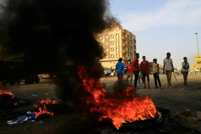 Demonstrators burn tires in the middle of a main street in Khartoum on July 27, 2019, as they protest against the results of the probe into the June raid on a Khartoum protest camp revealed.Demonstrators and rights groups had accused the paramilitary R...