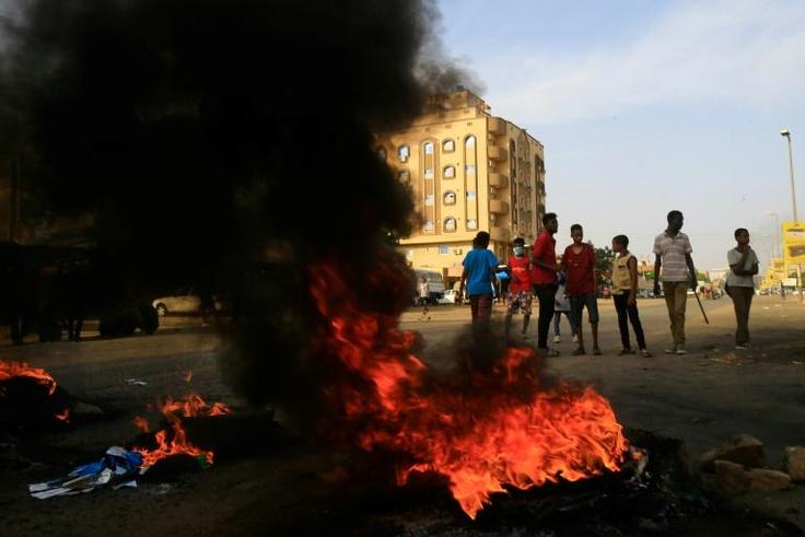 Demonstrators burn tires in the middle of a main street in Khartoum on July 27, 2019, as they protest against the results of the probe into the June raid on a Khartoum protest camp revealed.Demonstrators and rights groups had accused the paramilitary R...